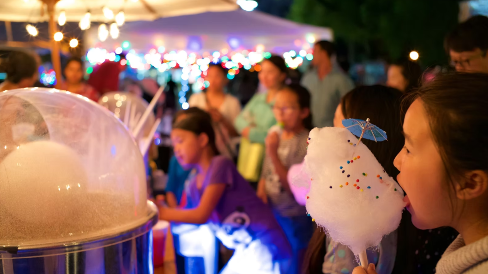 Attendees enjoy cotton candy at the Little Mekong Night Market.