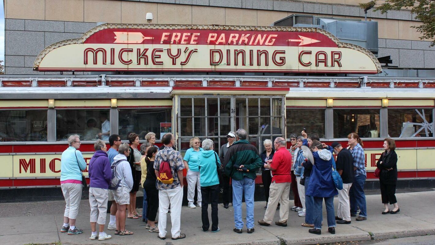 Participants in a St. Paul Walking Tour lear about this history of Mickey's Diner.