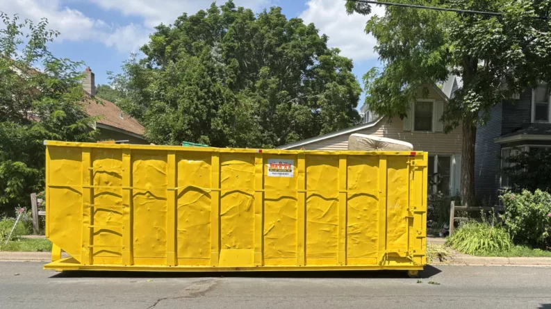 The big yellow dumpster in front of Mr. Positive's house.