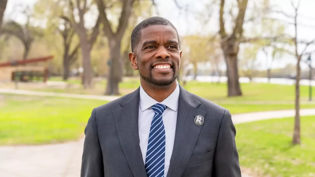 St. Paul Mayor Melvin Carter smiling in a park.