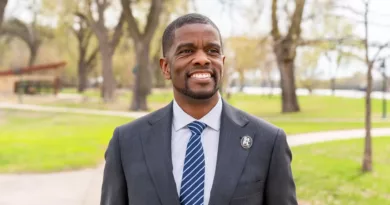 St. Paul Mayor Melvin Carter smiling in a park.