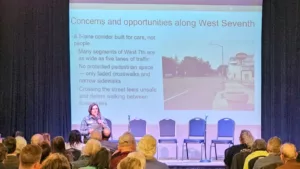 West 7th / Fort Road Federation Chair Meg Duhr presents at the Future of West 7th Town Hall on October 29, 2025.