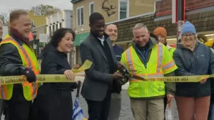 Mayor Melvin Carter cuts the construction tape to reopen Grand Avenue on October 21. Photo Courtesy Macalester-Groveland Community Council.