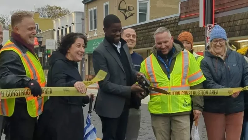Mayor Melvin Carter cuts the construction tape to reopen Grand Avenue on October 21. Photo Courtesy Macalester-Groveland Community Council.