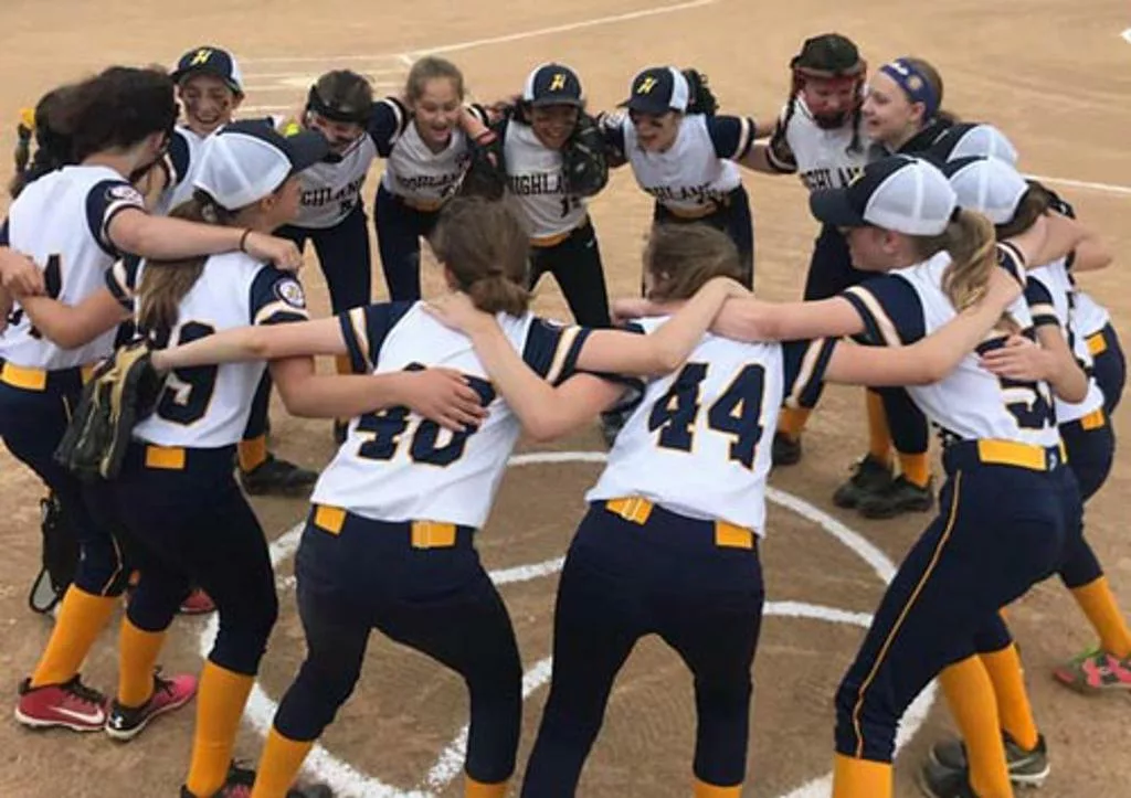 Softball players in a huddle